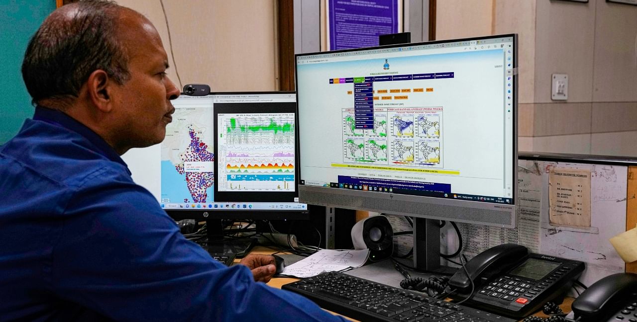An employee at the India Meteorological Department looks at the different models for analysis and forecasting in New Delhi. The India Meteorological Department as well as the state of Kerala have increased infrastructure for cyclone warnings since Cyclone Ockhi in 2017, which killed about 245 fishermen out at sea. Credit: PTI/AP Photo