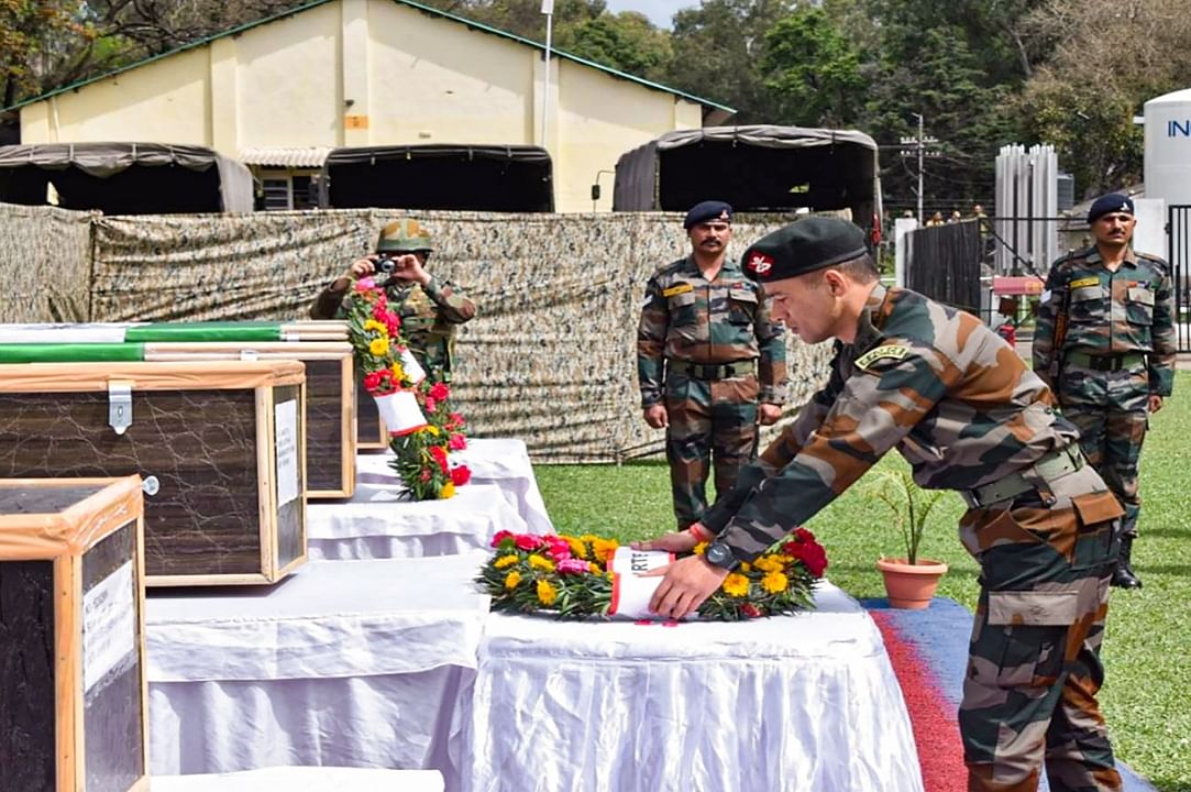 An army officer lays a wreath near the mortal remains of 5 soldiers who were killed in a terrorist attack in Poonch district. Credit: PTI Photo