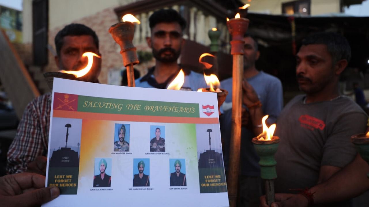 Members of the Traders Federation take part in a torch rally to pay tribute to Army martyrs who were killed in Thursday's terror strike in Poonch, in Jammu, Friday, April 21, 2023. Credit: PTI Photo