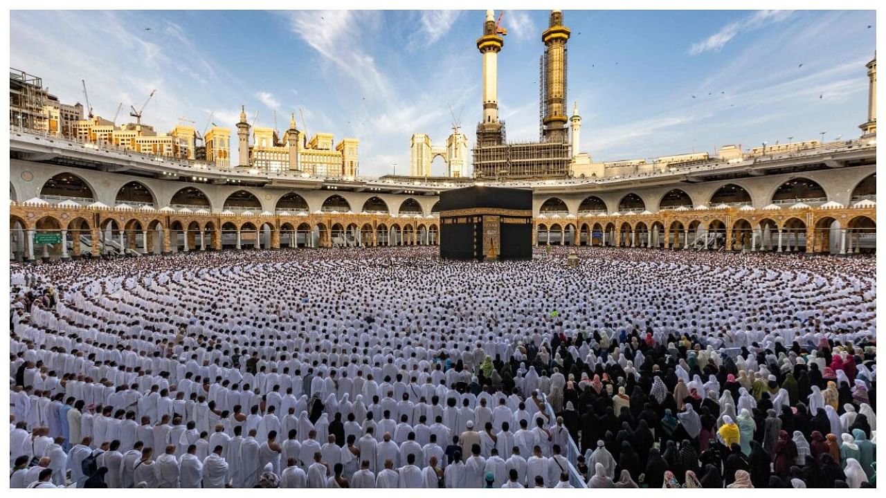 Muslim worshippers pray around the Kaaba, Islam's holiest shrine, at the Grand Mosque in the holy city of Mecca on the first day of Eid al-Fitr. Credit: AFP Photo