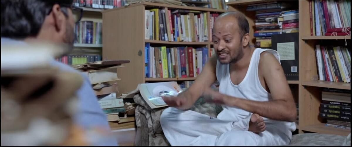 A character in 'Maavu Bevu' explaining the significance of the Indian text 'Siribhoovalaya'.