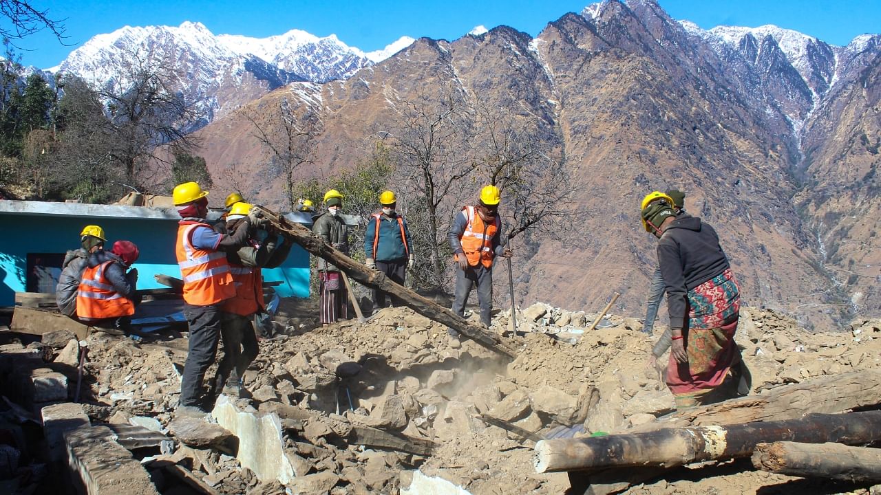 Workers demolish a house in the land subsidence affected Joshimath, January 2023. Credit: PTI Photo