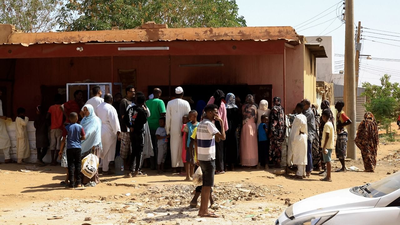 People gather to get bread during clashes between the paramilitary Rapid Support Forces and the Sudanese army in Khartoum North, Sudan, April 22, 2023. Credit: Reuters Photo