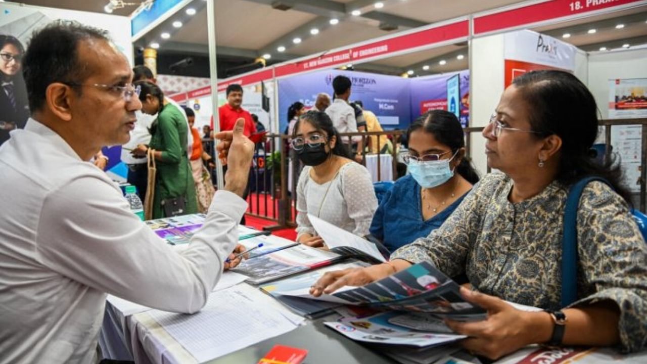 Parents and students are briefed on all they want to know at a stall at the expo. Credit: DH Photo