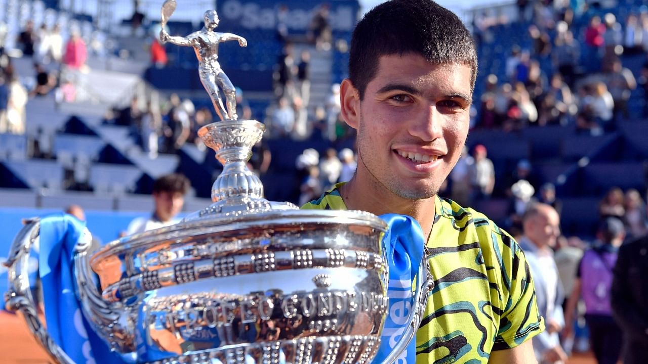 Spain's Carlos Alcaraz poses with his trophy after beating Greece's Stefanos Tsitsipas during the ATP Barcelona Open. Credit: AFP Photo
