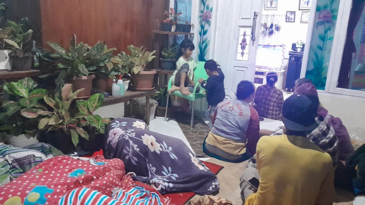 People outside their house after a magnitude 7.1 earthquake hit Muara Sikabaluan village, on Siberut Island on April 25, 2023. Credit: AFP Photo