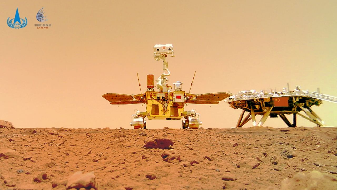 Chinese rover Zhurong and the lander of the Tianwen-1 mission, captured on the surface of Mars by a camera detached from the rover, are seen in this image released by China National Space Administration (CNSA) June 11, 2021. Credit: CNSA/Handout via Reuters Photo