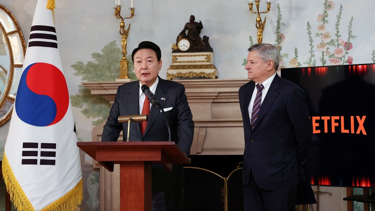 South Korean President Yoon Suk Yeol speaks next to Netflix co-CEO Ted Sarandos during a news conference in Washington, US, April 25, 2023. Credit: Yonhap via Reuters Photo