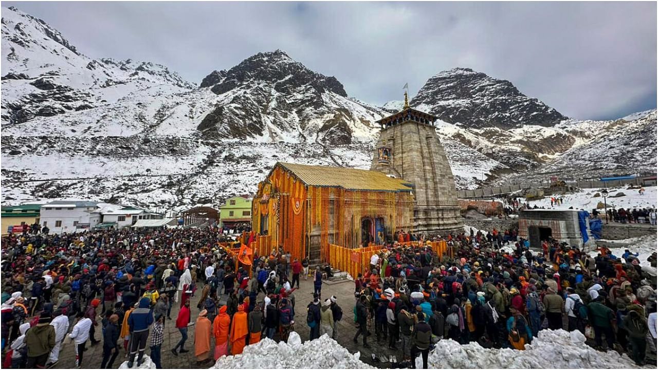 Devotees arrive to offer prayers at the Kedarnath Temple after its doors opened marking the Char Dham Yatra, in Kedarnath. Credit: PTI Photo