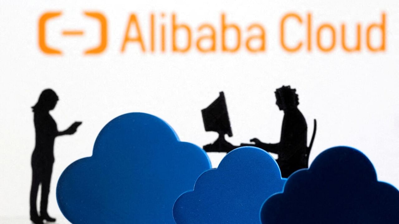 3D printed clouds and figurines are seen in front of the Alibaba Cloud service logo in this illustration taken February 8, 2022. Credit: Reuters Photo
