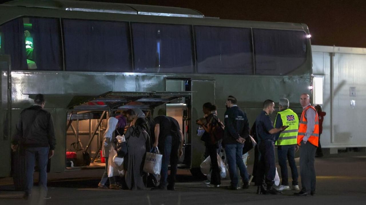 Evacuees from Sudan board a bus after disembarking from a British Royal Air Force military transport at Larnaca airport in Cyprus. Credit: AFP Photo