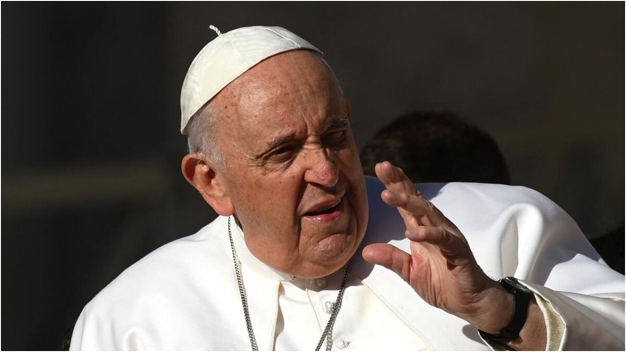 Pope Francis waves as he arrives for his weekly general audience at Saint Peters' square in the Vatican. Credit: AFP Photo