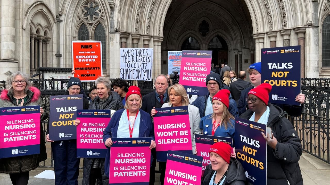 Royal College of Nursing General Secretary Pat Cullen and nurses hold banners as they demonstrate outside the Royal Courts of Justice in London, Britain, April 27, 2023. Credit: Reuters Photo