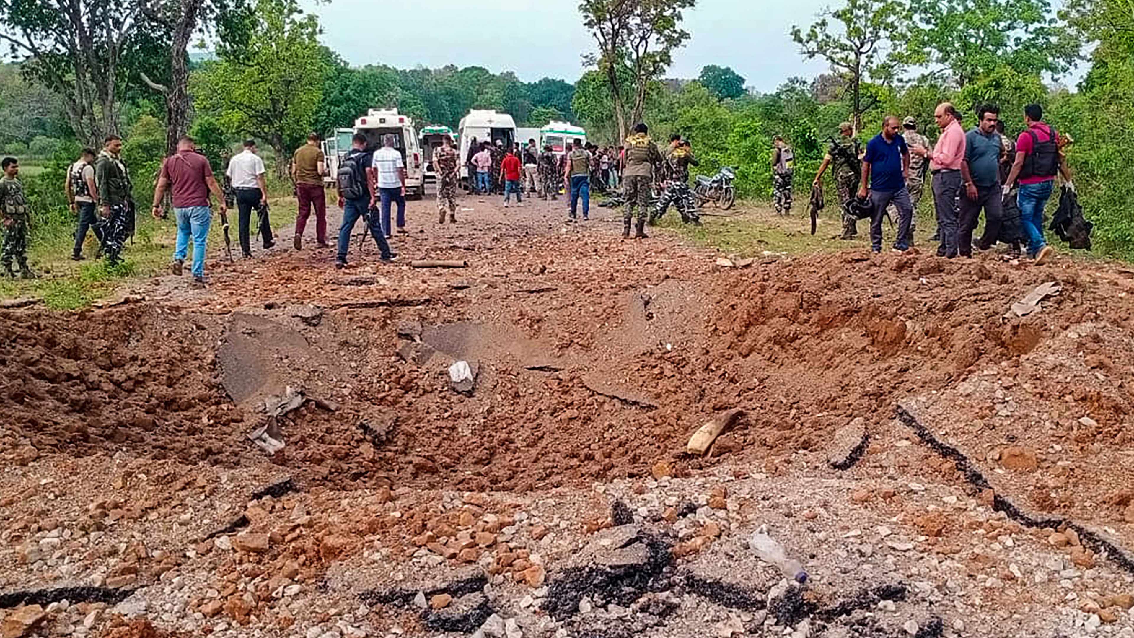 Security personnel at the site after at least ten police personnel and a driver were killed in a blast carried out by Naxalites in Chhattisgarh's Dantewada district. Credit: PTI Photo