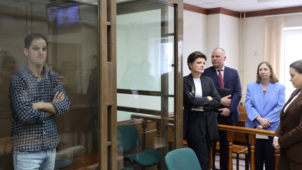 Wall Street Journal reporter Evan Gershkovich, who was detained in March while on a reporting trip and charged with espionage, stands behind a glass wall of an enclosure for defendants, while US Ambassador to Russia Lynne Tracy and lawyers Tatyana Nozhkina and Maria Korchagina appear in a courtroom before a hearing to consider an appeal against Gershkovich's detention, in Moscow, Russia, April 18, 2023. Credit: Reuters File Photo