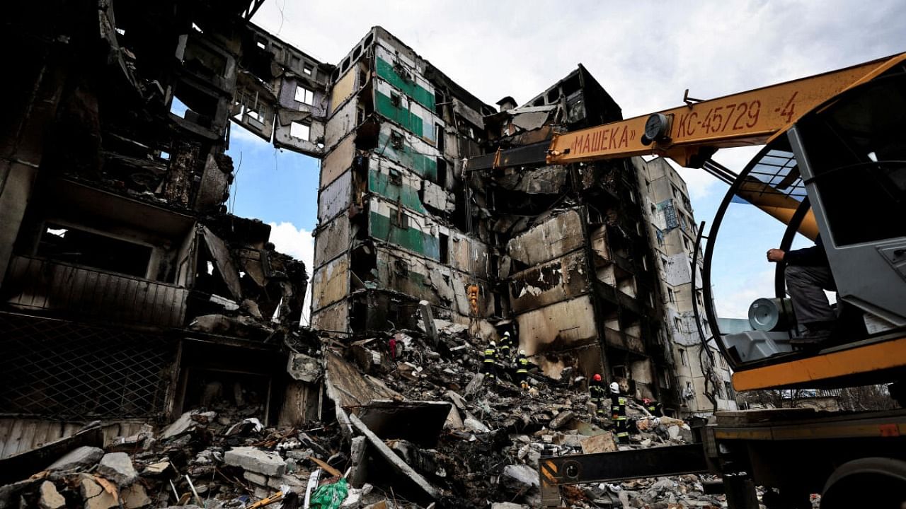 A rescuer walks during a search operation for bodies under the rubble of a building destroyed by Russian shelling, amid Russia's Invasion of Ukraine, in Borodianka, Kyiv region, Ukraine April 11, 2022. Credit: Reuters Photo