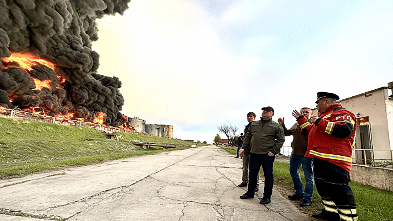 Firefighters looking at a burning fuel depot in Sevastopol as a drone hit a Crimea fuel depot overnight. Credit: AFP Photo