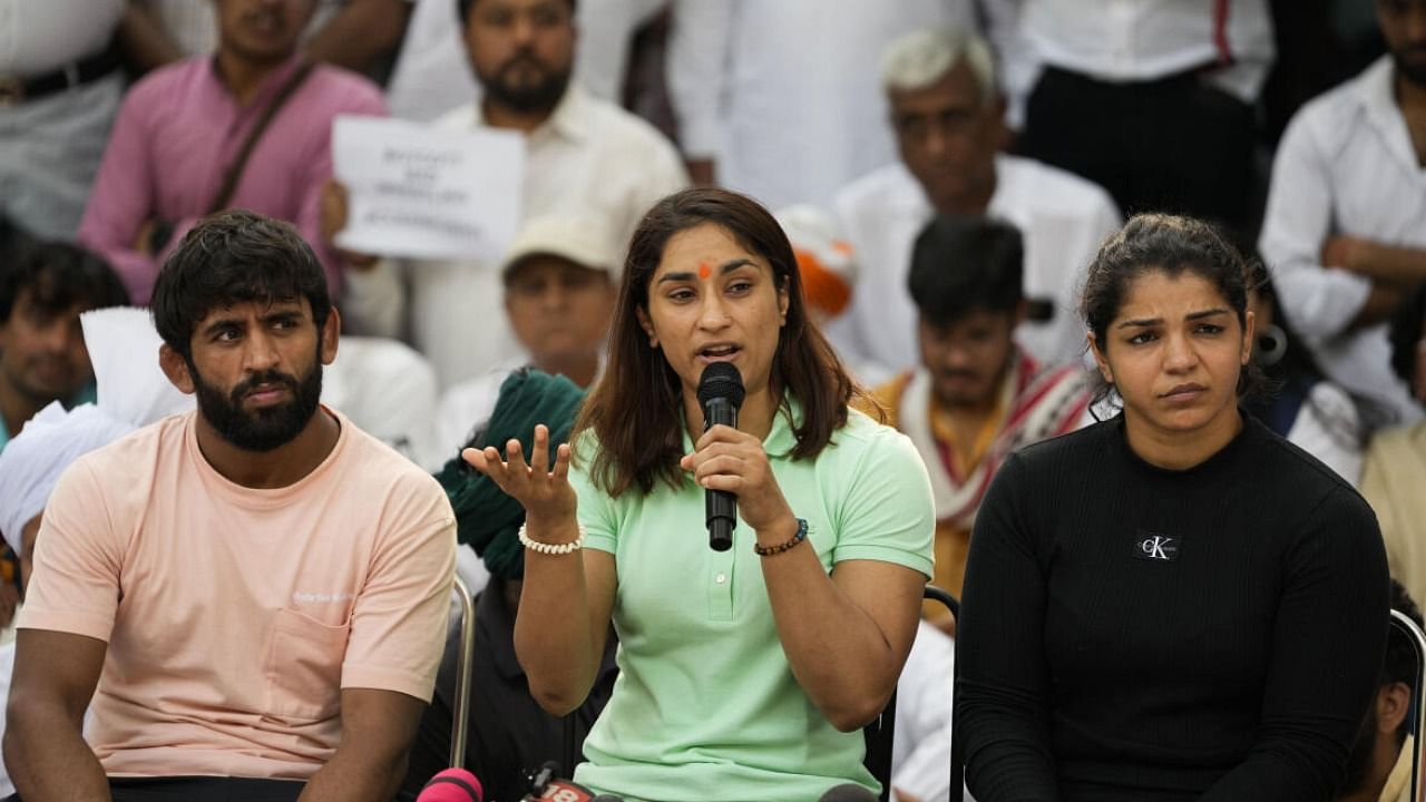 Wrestlers Bajrang Punia, Vinesh Phogat and Sakshi Malik addresses a press conference during their ongoing protest at Jantar Mantar, in New Delhi. credit: PTI Photo