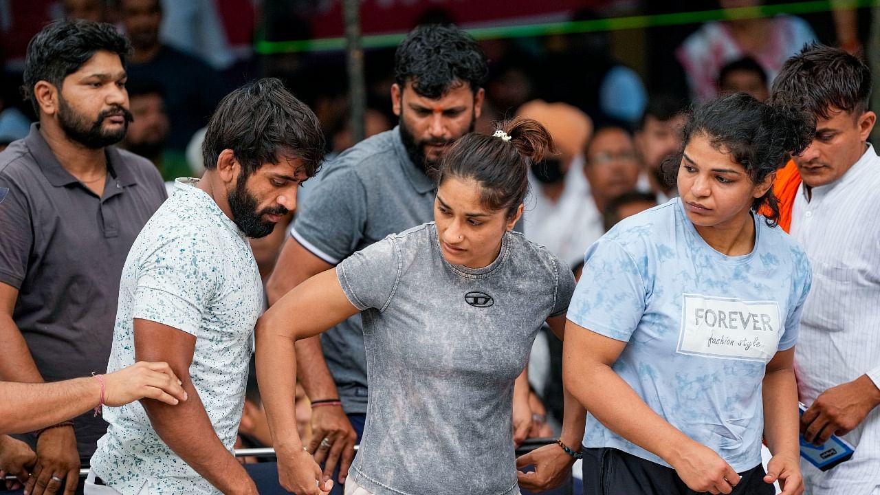 Wrestlers Bajrang Punia, Vinesh Phogat and Sakshi Malik during their protest at Jantar Mantar. Credit: PTI Photo