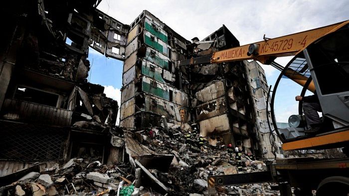 A rescuer walks during a search operation for bodies under the rubble of a building destroyed by Russian shelling, amid Russia's Invasion of Ukraine, in Borodianka, Kyiv region, Ukraine April 11, 2022. Credit: Reuters Photo