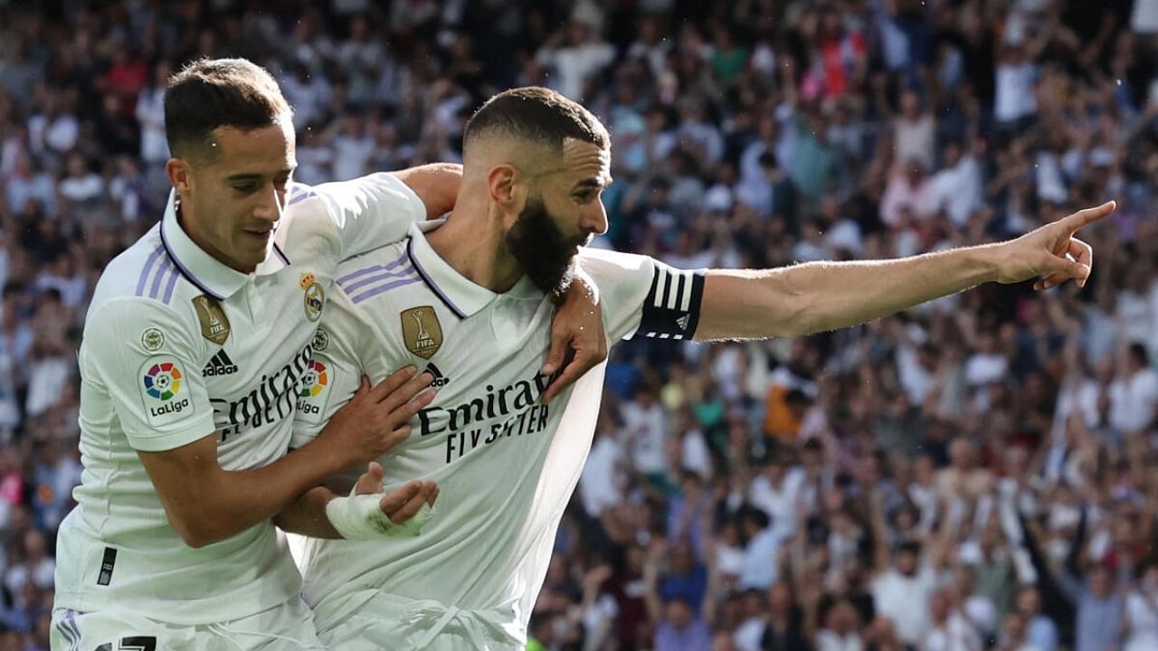 Real Madrid's French forward Karim Benzema (R) celebrates scoring his team's second goal during the Spanish league football match between Real Madrid CF and UD Almeria at the Santiago Bernabeu stadium in Madrid. Credit: AFP Photo