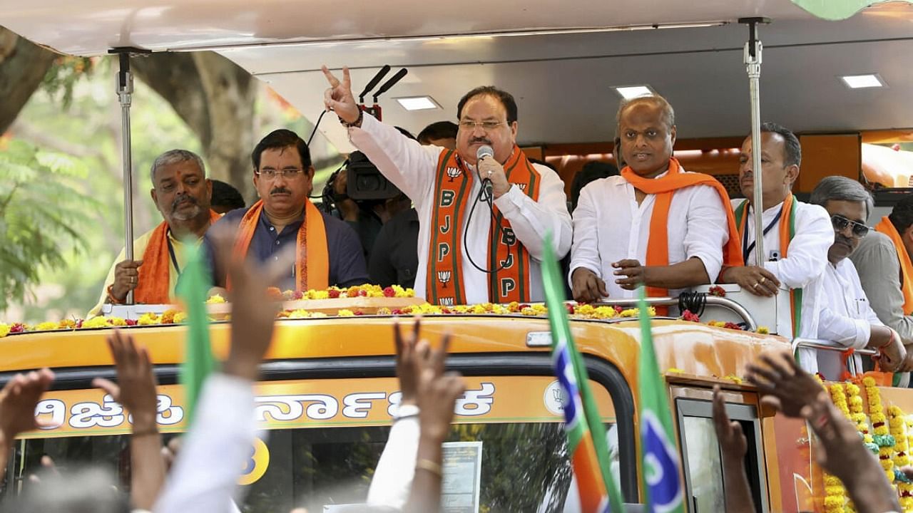 BJP national president JP Nadda with senior leader Pralhad Joshi and others during an election campaign roadshow in Kalaghatagi of Dharwad district on Saturday. PTI Photo