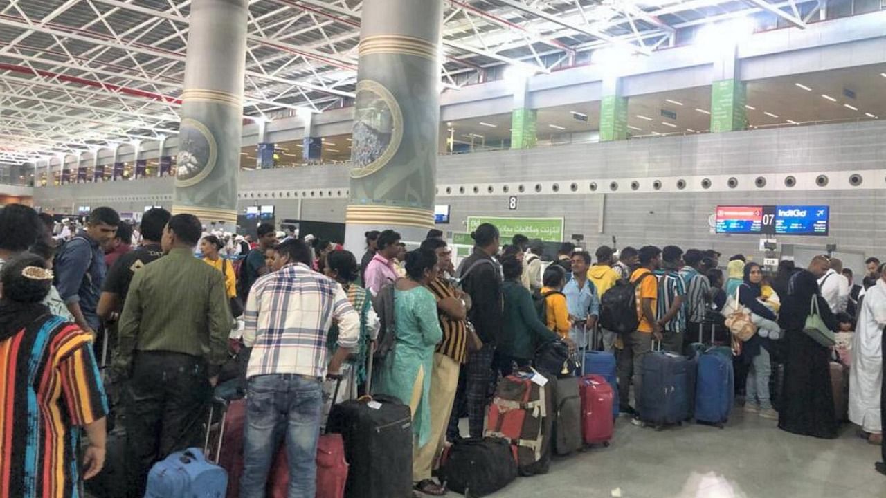 Indian nationals, evacuated from violence-hit Sudan under Operation Kaveri, queue to board a flight for Bengaluru. Credit: PTI Photo