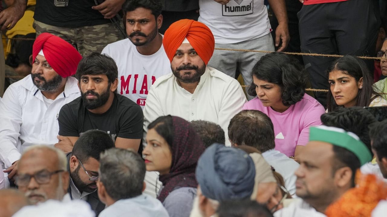 Congress leader Navjot Singh Sidhu with wrestlers Bajrang Punia, Sakshi Malik and others during the wrestlers' protest at Jantar Mantar. Credit: PTI Photo