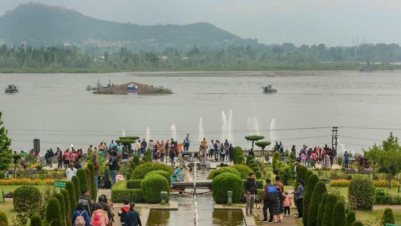 Tourists visit the Nishat Mughal Gardens on the banks of Dal Lake in Srinagar. Credit: PTI Photo