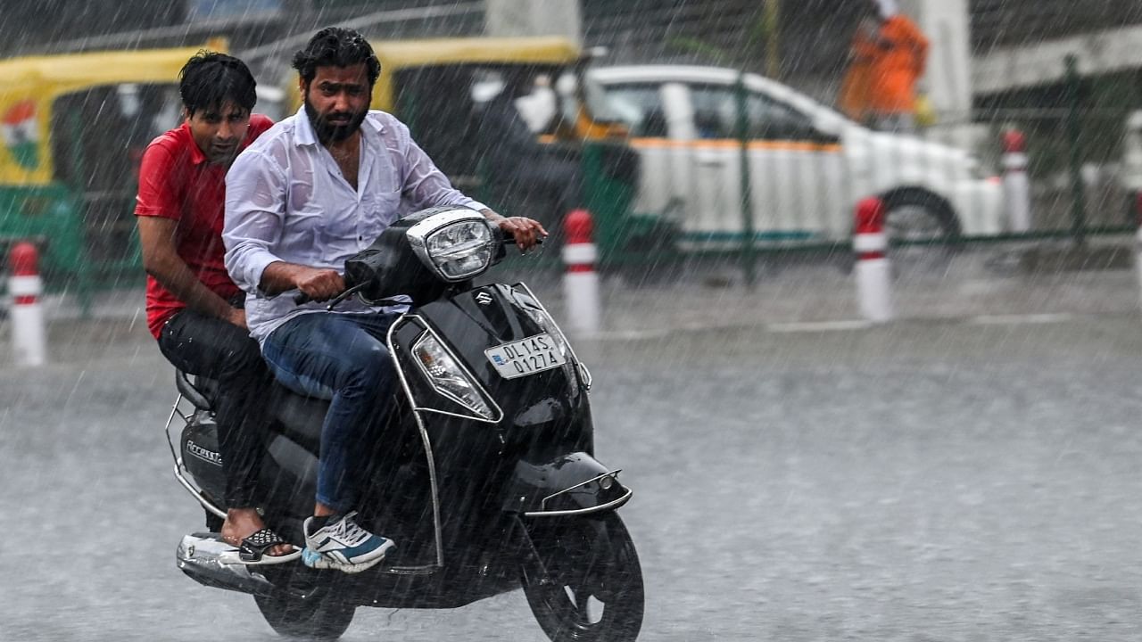 Motorist make their way amid a rainfall in New Delhi on May 1. Credit: AFP Photo