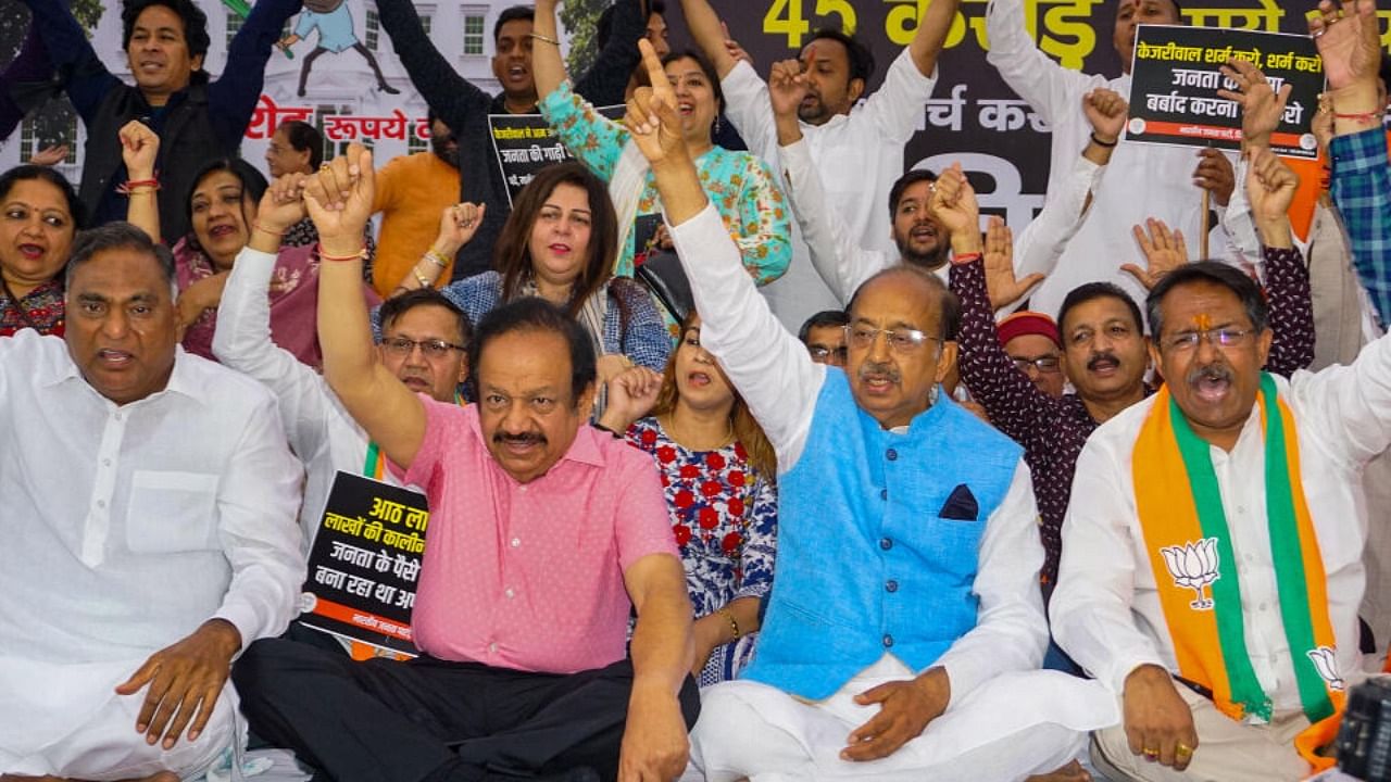 BJP MP Harsh Vardhan with party leaders Ramvir Singh Bidhuri and Vijay Goel raises slogans during a protest against Delhi Chief Minister Arvind Kejriwal, accusing him of spending crores on the renovation of his official residence, in New Delhi, Monday, May 1, 2023. Credit: PTI Photo