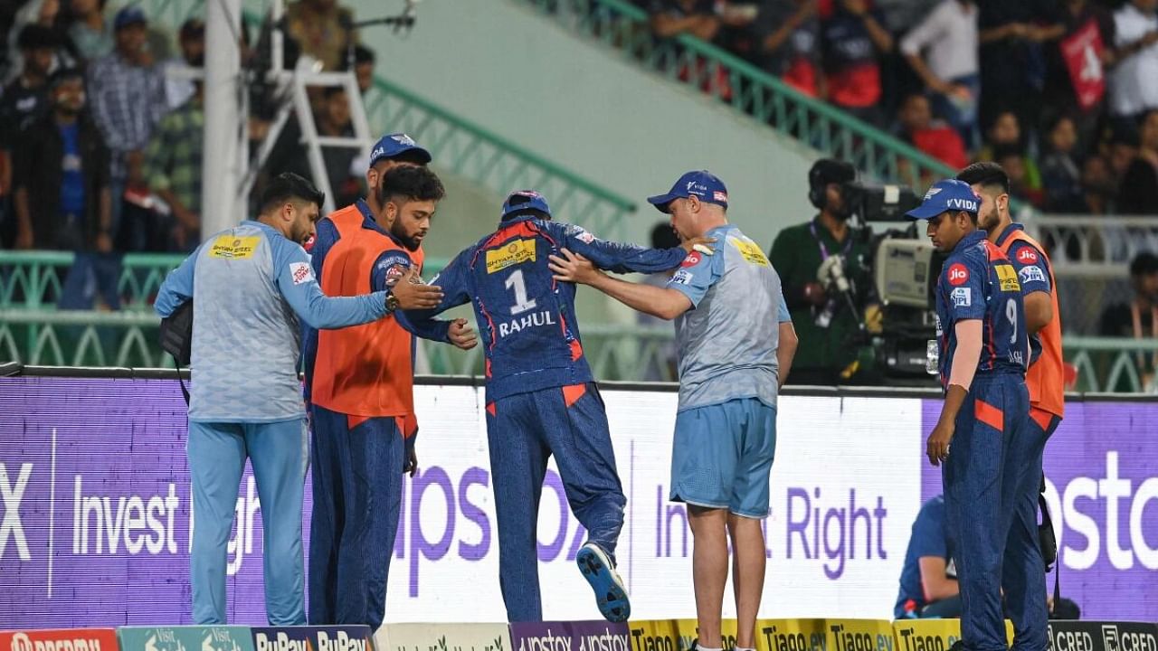 K L Rahul being helped off the field by medics and teammates. Credit: AFP Photo