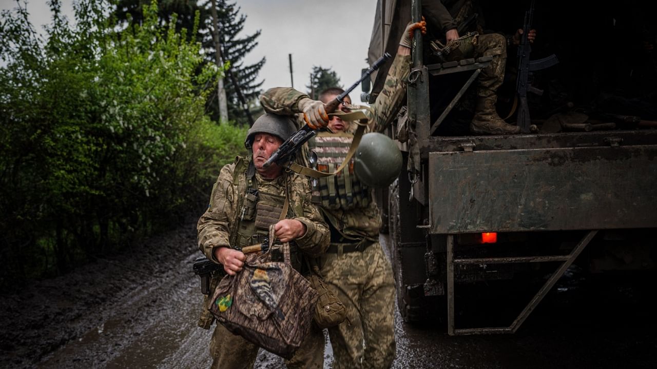 Ukrainian servicemen disembark a military truck near the frontline town of Bakhmut, Donetsk region, on April 30, 2023, amid the Russian invasion of Ukraine. Credit: AFP Photo