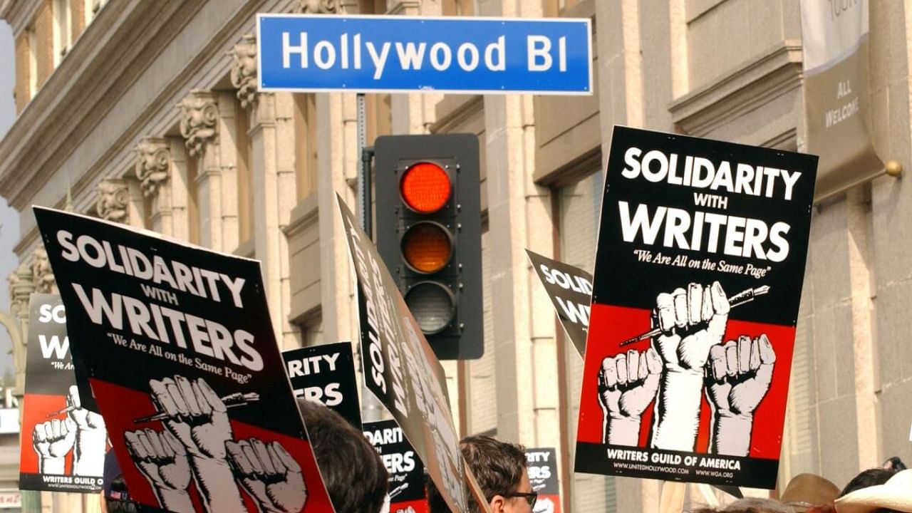 This November 20, 2007 photo shows demonstrators holding signs during the 2007–2008 Writers Guild of America strike in Hollywood. Credit: AFP Photo