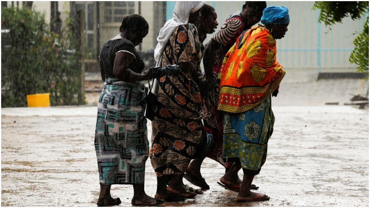 Relatives of the followers of a Christian cult named as Good News International Church, who believed they would go to heaven if they starved themselves to death in Shakahola, mourn as they walk in the rain outside the Malindi sub district hospital mortuary in Malindi, Kilifi county, Kenya April 27, 2023.  Credit: Reuters Photo