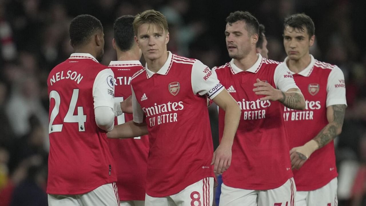 Arsenal's Martin Odegaard, centre, celebrates after the match at the Emirates Stadium in London. Credit: AP/PTI Photo