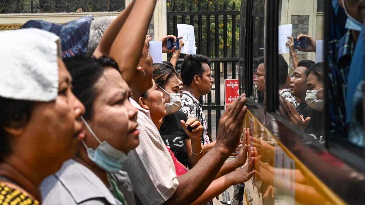 Relatives gather around a bus carrying prisoners being released outside the Insein prison in Yangon on May 3, 2023. Credit: AFP Photo