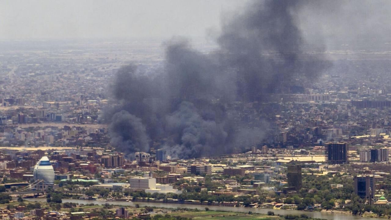 Smoke billows during fighting in the Sudanese capital Khartoum. Credit: AFP Photo