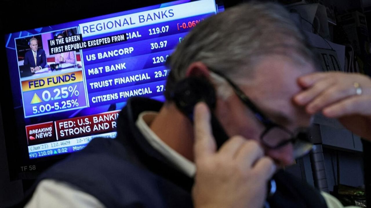 A Trader reacts as a screen displays the Fed rate announcement on the floor of the New York Stock Exchange (NYSE) in New York City, US. Credit: Reuters Photo