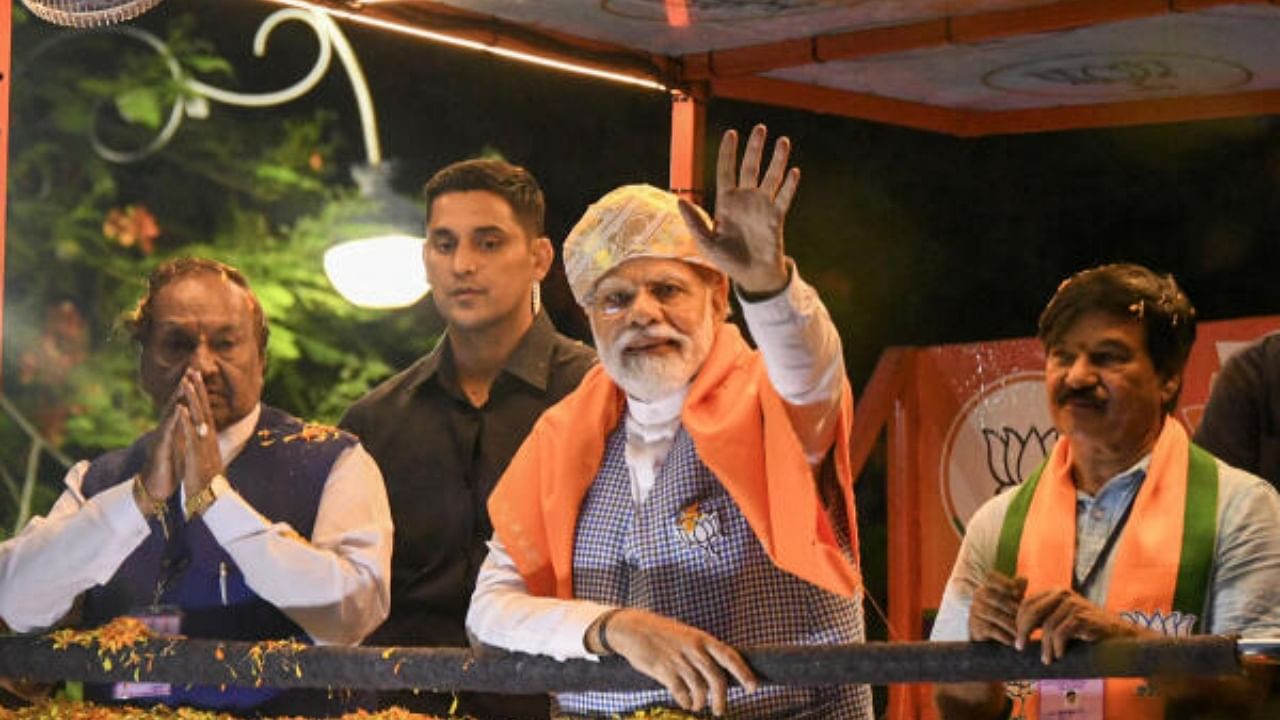 Prime Minister Narendra Modi waves at supporters during a roadshow ahead of the Karnataka Assembly elections, in Mysuru. Credit: PTI Photo