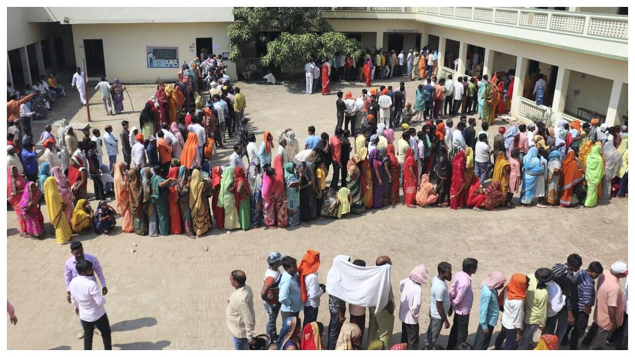 Voters wait in a queue at a polling station to cast their votes for the UP Municipal elections, in Gorakhpur, Thursday, May 4, 2023. Credit: PTI Photo