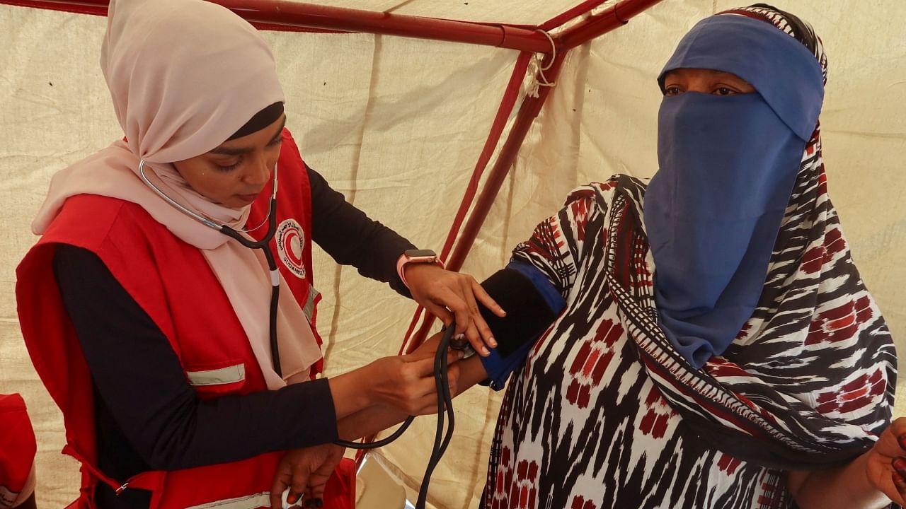 A woman receives medical attention inside the Sundanese Red Crescent tent at camp center to be processed for evacuation, following the crisis in Sudan's capital Khartoum, in Port Sudan, Sudan, May 4, 2023. Credit: Reuters Photo