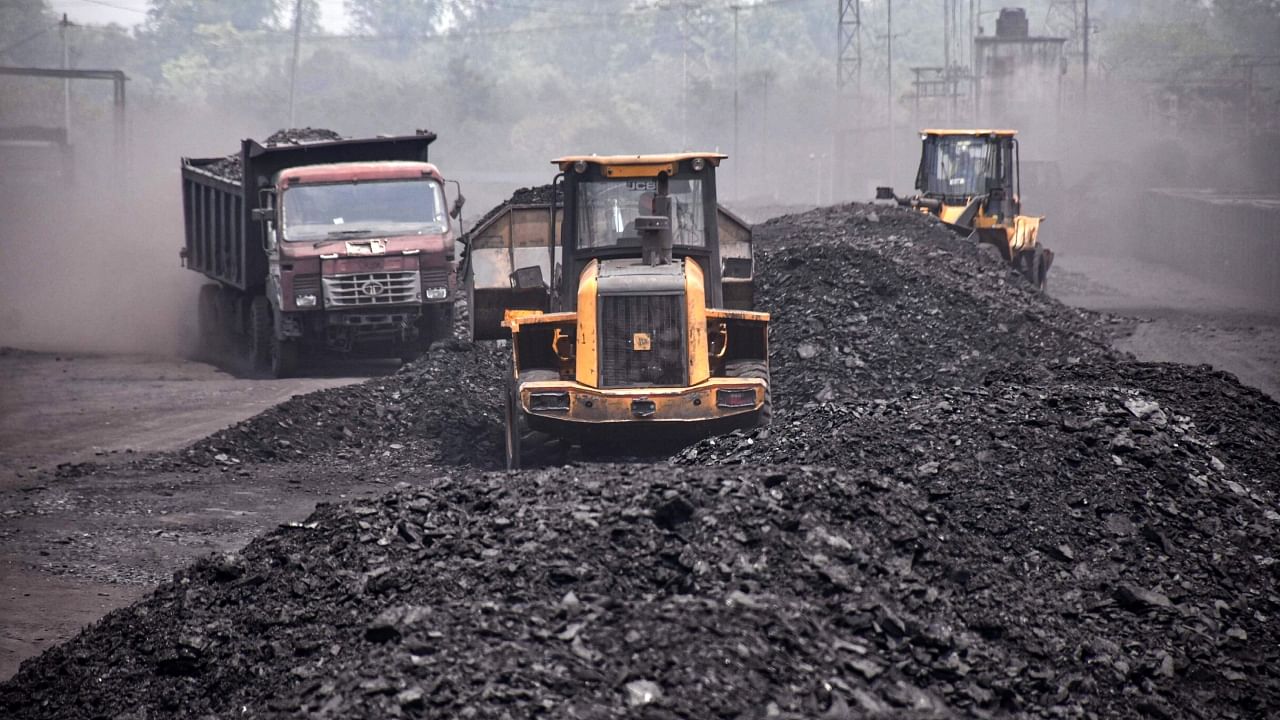 Labourers carry coal onto goods train at Ashoka Coal Mines in Peeparwar, Jharkhand. Credit: PTI File Photo