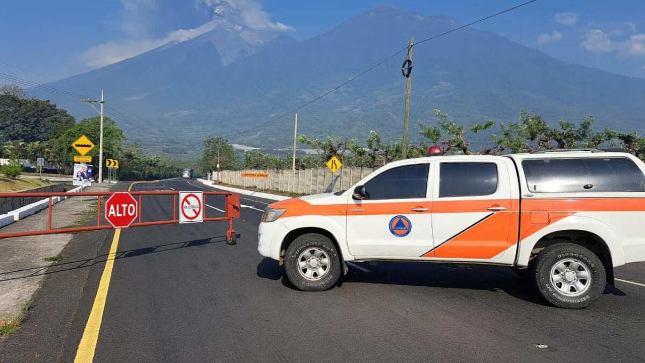 A vehicle of the Guatemala's disaster management agency (CONRED) blocks a road as the Fuego volcano spews a column of steam during an increase of its activity, in Alotenango, Guatemala May 4, 2023. Credit: Reuters
