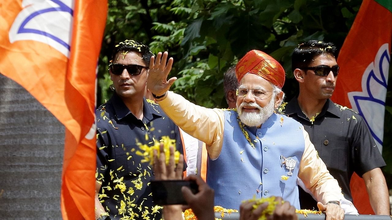 Prime Minister Narendra Modi during a roadshow at Puttenahalli , BTM layout Assembly constituency. Credit: PTI Photo