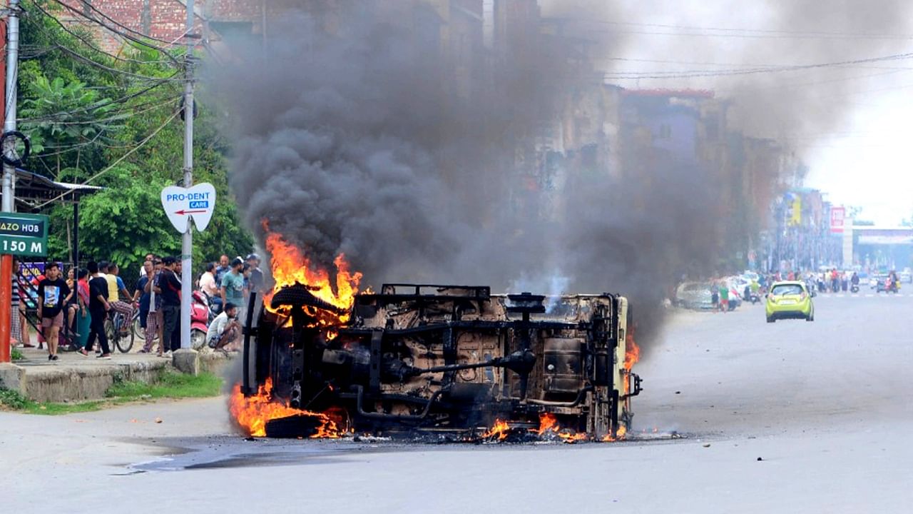 Smoke billows from a vehicle allegedly burned by the Meitei community tribals protesting to demand inclusion under the Scheduled Tribe category, in Imphal, Manipur. Credit: AFP Photo
