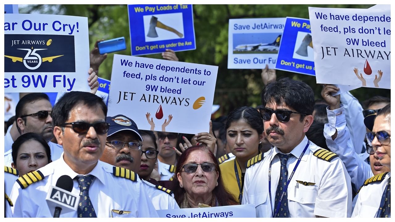 Pilots, cabin crew and ground staff hold placards during a protest organized by Jet Airways India employees in Delhi in 2019. Credit. Bloomberg