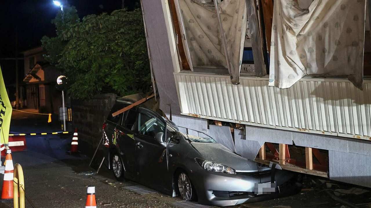 A car crushed by a collapsed house is pictured in the city of Suzu, Ishikawa prefecture early on May 6, 2023, after a 6.5 magnitude earthquake hit the area the day before. Credit: AFP Photo
