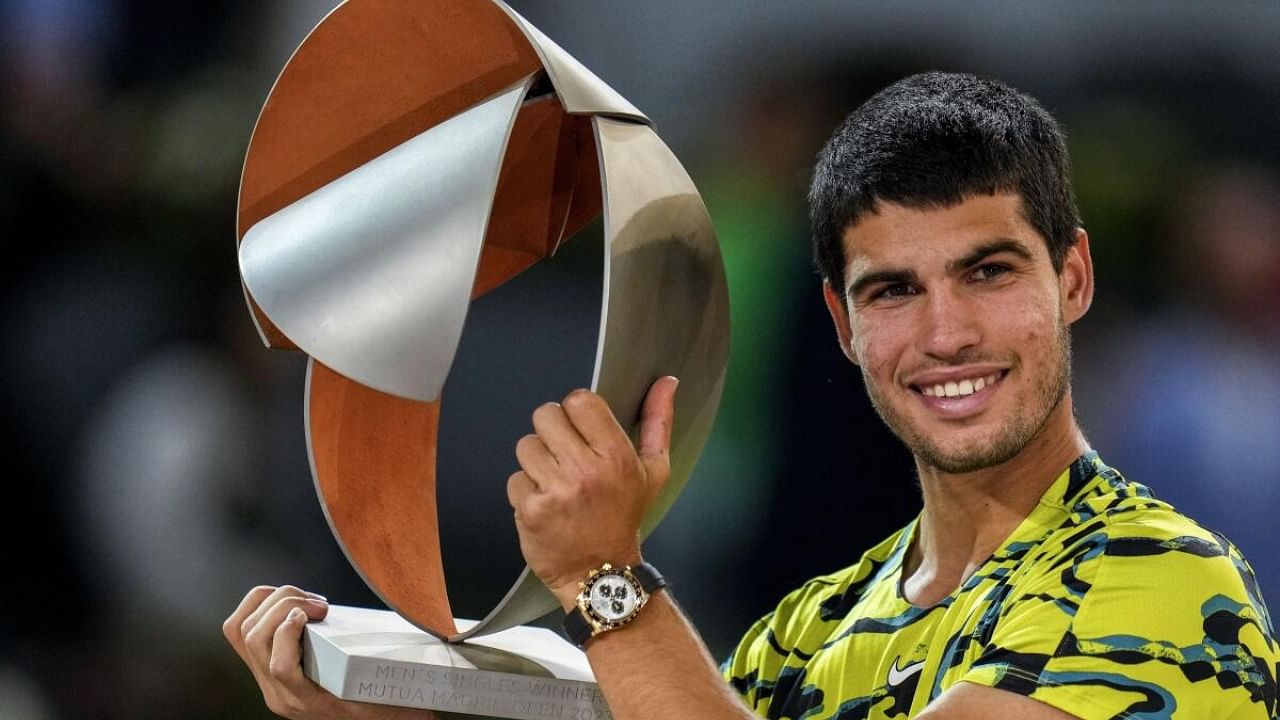 Carlos Alcaraz, of Spain, holds the winner's trophy after defeating Jan-Lennard Struff, of Germany, in the men's final at the Madrid Open tennis tournament in Madrid, Spain. Credit: AP/PTI Photo
