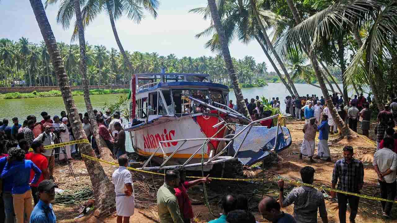 Onlookers gather near the site of a boat accident in Tanur, in Malappuram district on May 8, 2023. - At least 22 people died when a double-decker tourist boat capsized in India's southern state of Kerala, officials said. Credit: AFP Photo